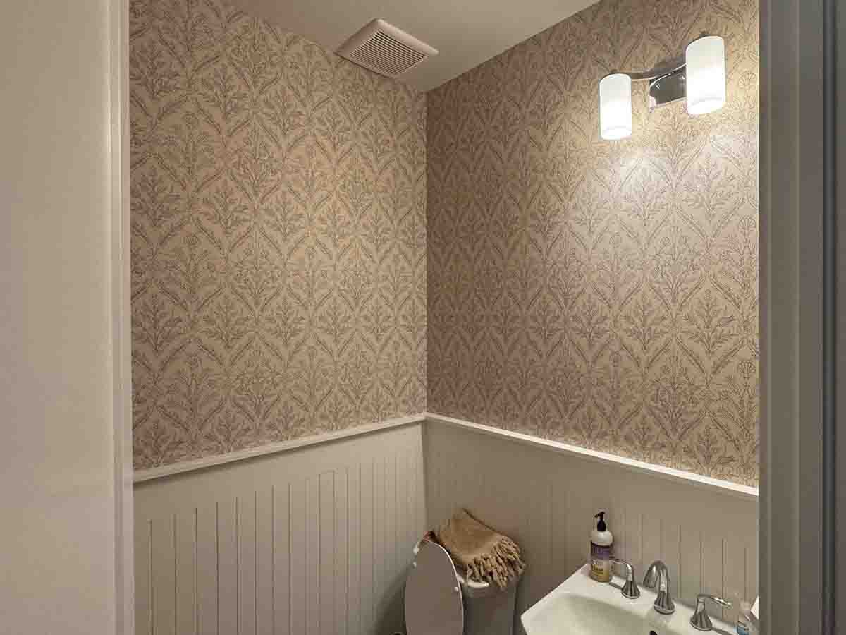 Non-woven wallpaper installation bathroom above wainscoting Denver metro area