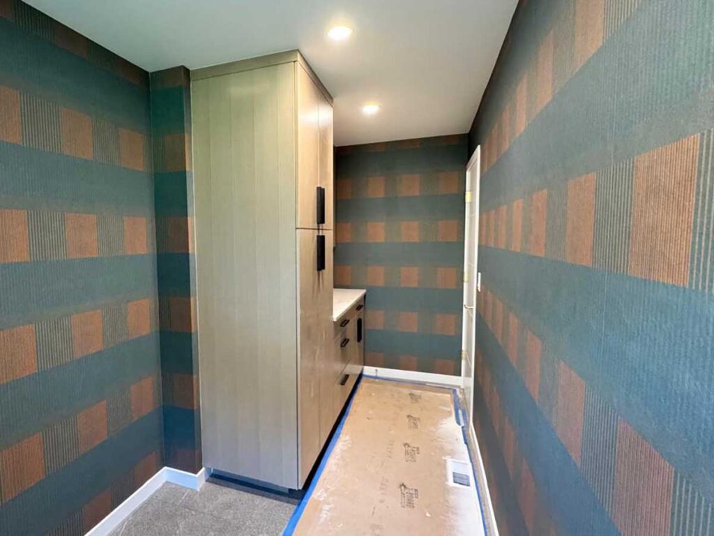 Full laundry room wallpaper installation in Denver metro area with geometric pattern and continuous wall coverage