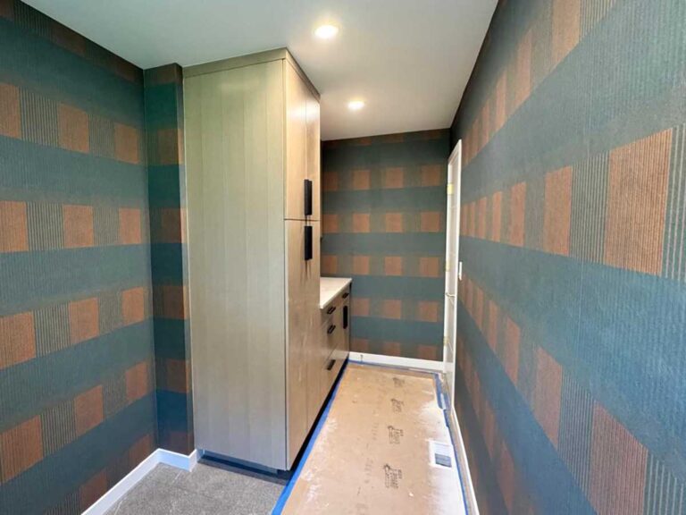 Full laundry room wallpaper installation in Denver metro area with geometric pattern and continuous wall coverage