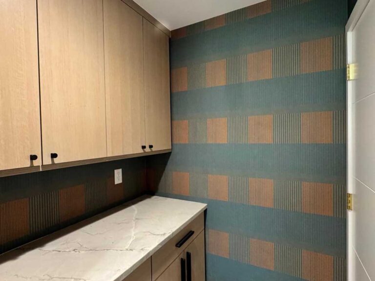 Laundry room wallpaper installation in Denver metro area with geometric pattern and precise cutting around cabinets