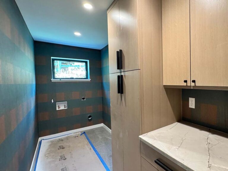 Laundry room wallpaper installation in Denver metro area with geometric pattern and cabinetry integration