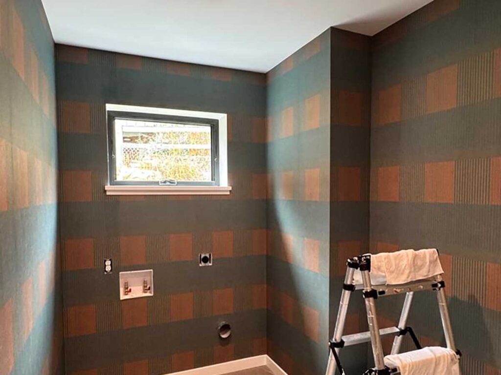 Wallpaper installation in laundry room in Denver metro area with geometric pattern and clean corner alignment