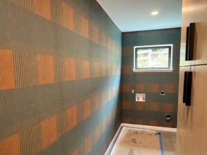 Wallpaper installation in laundry room in Denver metro area with geometric pattern and precise alignment