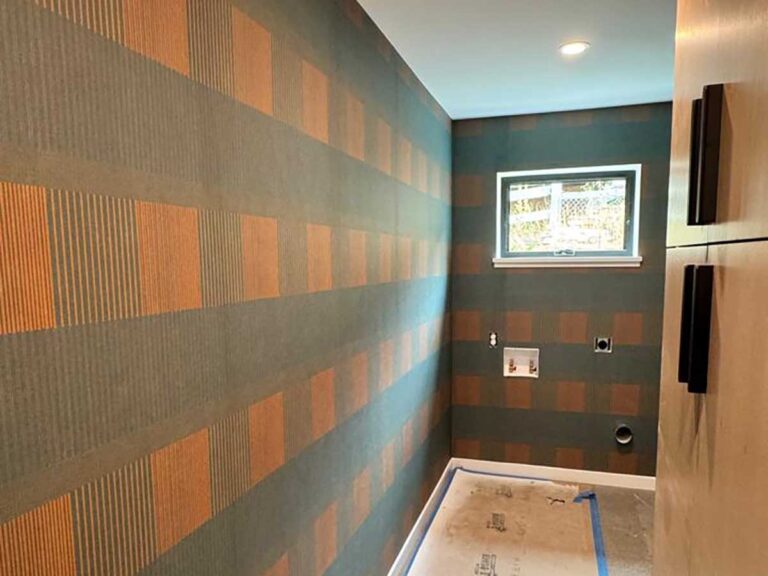 Wallpaper installation in laundry room in Denver metro area with geometric pattern and precise alignment
