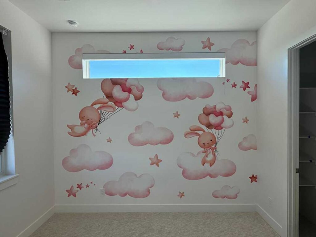 Kids room wall mural installation in Denver metro area with clouds, stars and bunny illustration design