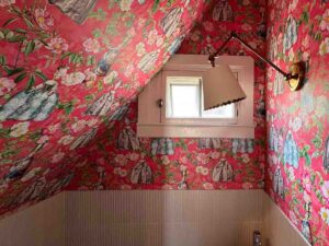Wallpaper installation in Denver metro area powder room with bold floral pattern on sloped ceiling and walls