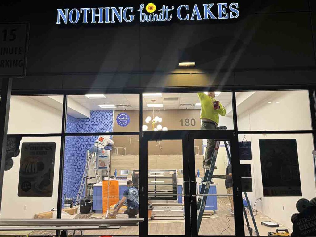 Commercial Type II vinyl wallpaper installation at Nothing Bundt Cakes in Fort Collins, Colorado during an overnight commercial construction project