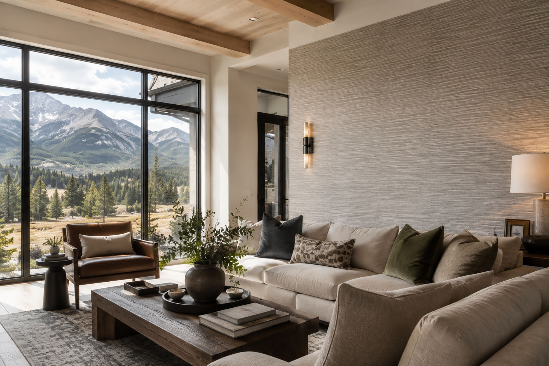 Luxury Colorado living room featuring a professionally installed textured wallpaper accent wall with panoramic Rocky Mountain views through floor-to-ceiling windows.