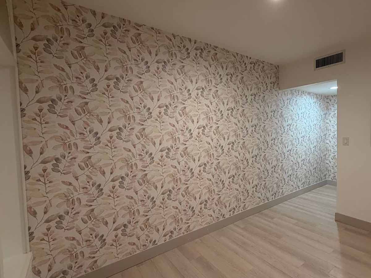Professional wallpaper installation in Dacono, Colorado featuring a modern botanical wallpaper with perfectly matched seams in a residential hallway.
