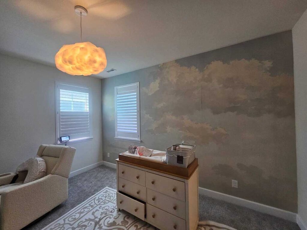 Professional mural wallpaper installation in a nursery in Delta, Colorado featuring a soft cloud wall mural with seamless panel alignment.
