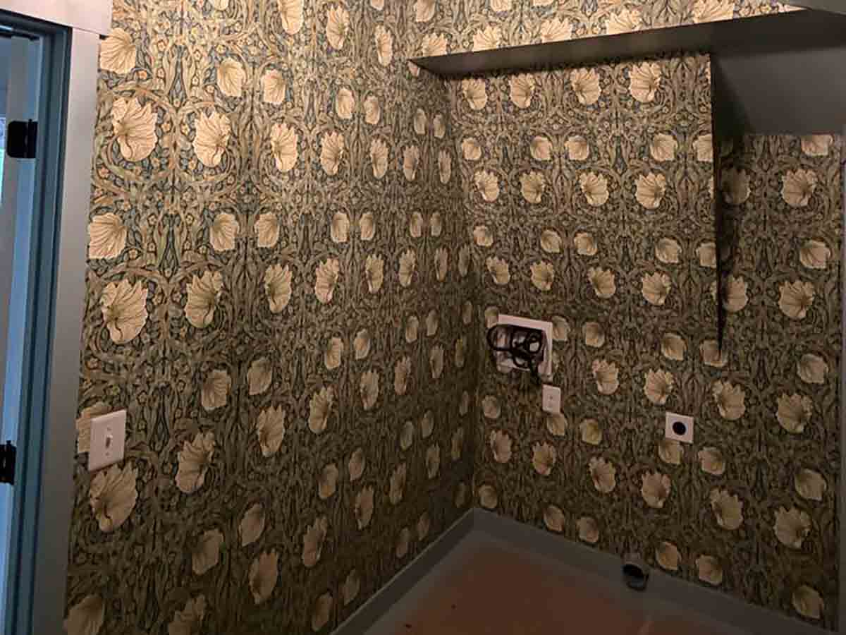 Professional wallpaper installation in Eagle, Colorado featuring an elegant floral wallpaper in a luxury powder room with precise pattern matching around fixtures and corners.
