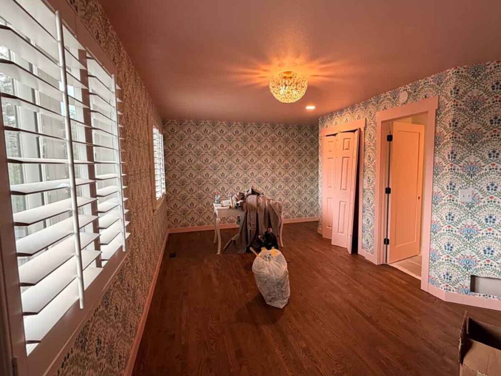 Professional wallpaper installation in Elizabeth, Colorado featuring decorative patterned wallpaper throughout a bedroom with seamless pattern alignment and precision finishing.