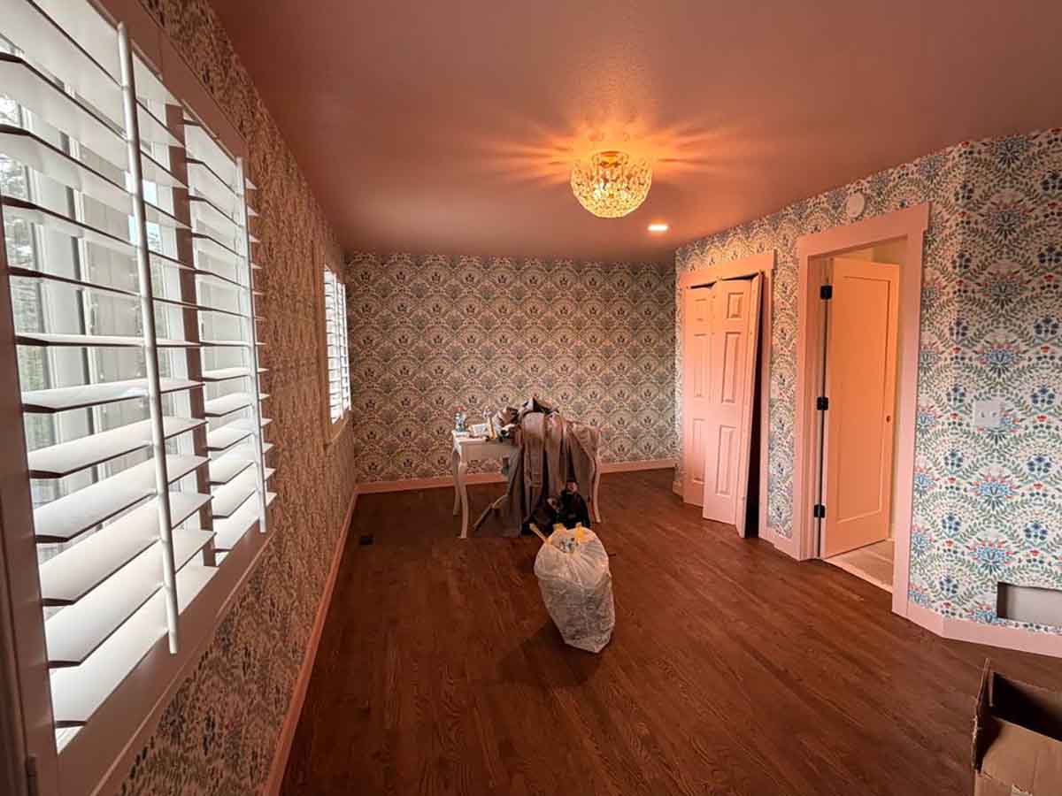 Professional wallpaper installation in Elizabeth, Colorado featuring decorative patterned wallpaper throughout a bedroom with seamless pattern alignment and precision finishing.
