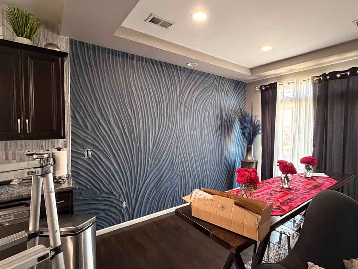 Professional mural wallpaper installation in Erie, Colorado featuring a modern blue textured wall mural in a dining room with seamless panel alignment.