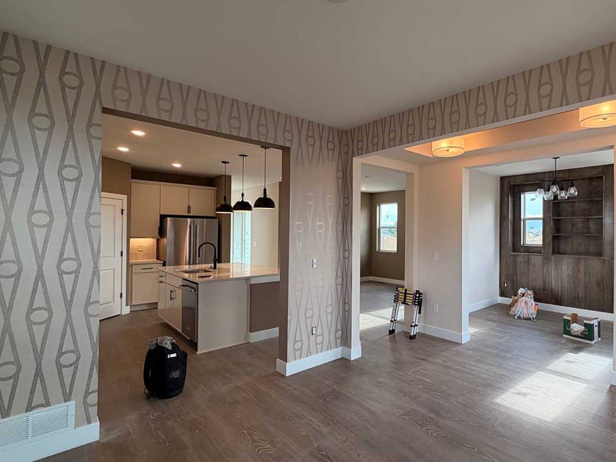 Professional geometric wallpaper installation in Glenwood Springs, Colorado featuring a contemporary wallcovering in an open-concept living area with seamless pattern matching.